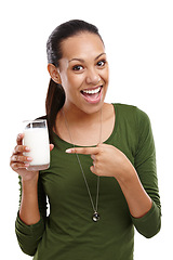 Image showing Woman, portrait and milk for detox in studio, dairy and milkshake for nutrition on white background. Female person, pointing and proud of vanilla smoothie for diet, weight loss and organic vitamin d