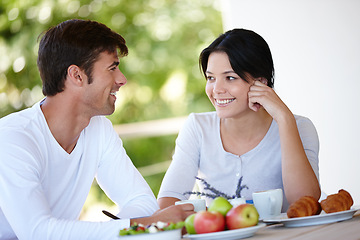 Image showing Couple, balcony and outdoors together for meal, love and affection in marriage or romance in nature. People, nutrition and smile at breakfast for healthy relationship, food and relax on vacation