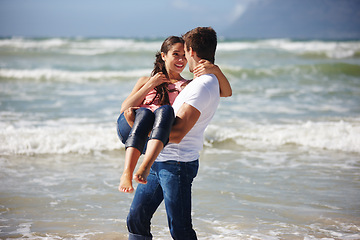 Image showing Ocean, couple and man carrying woman, travel to beach for bonding and anniversary in nature. Happiness, partner and trust in relationship for romance, affection and playful outdoor for love and fun