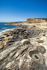 Image showing Crystal clear turquoise water in blue lagoon. St. Peters pool - rocky beach at Malta