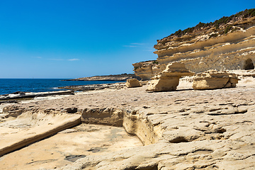 Image showing Crystal clear turquoise water in blue lagoon. St. Peters pool - rocky beach at Malta