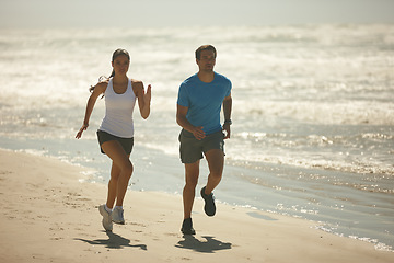 Image showing Couple, fitness and running on beach with exercise, workout or outdoor training together in nature. Man and woman enjoying walk or run for physical activity or cardio on the ocean coast with partner