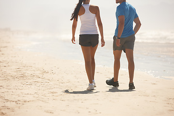 Image showing Couple, fitness and walking on beach with partner for workout, exercise or training together in nature. Rear view of active man and woman in stroll, cardio or health and wellness on the ocean coast