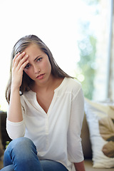 Image showing Woman, home and portrait with anxiety on sofa for stress, worried or concern or tension. Female person, house and headache with hand for trouble or fear, unhappy or miserable or mental health