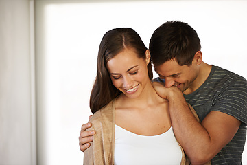 Image showing Touch, couple and laugh in embrace for love, marriage and romance or care in home. Happy people, hug and humor or funny joke for pride in relationship or commitment, loyalty and connection on date