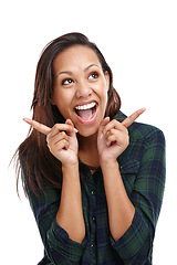 Image showing Woman, looking away and hand gesture with smile, fashion and shirt in white background or studio. Female person, expression and happy for clothing, apparel and outfit in backdrop, cheerful and edgy