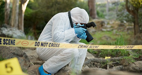 Image showing Forensic, photographer and police tape at crime scene for investigation in forest with evidence and safety hazmat..Csi quarantine, expert investigator and pictures for observation and case research