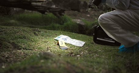 Image showing Csi, photographer and evidence at crime scene for investigation in forest with wallet or safety hazmat..Forensic photography, expert investigator and pictures for observation or case research outdoor