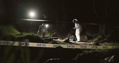 Image showing Forensic team, photographer and crime scene at night for investigation or observation with hazmat or police tape. Collaboration, expert investigator or outdoor in forest for evidence or case research