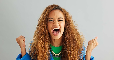 Image showing Excited woman, fist pump and celebration with deal, promotion or winning on a gray studio background. Portrait of happy female person or young winner with smile in surprise for bonus on mockup space