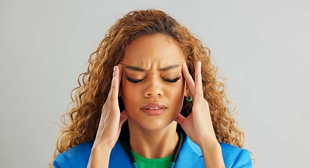 Image showing Frustrated woman, headache and stress with anxiety, mental health or depression on a gray studio background. Face of tired female person in fatigue, pressure or tension with overwhelmed emotion