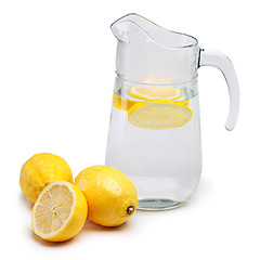 Image showing Lemon, fruit and citrus with jug of water for vitamin c, hydration or healthy nutrition on white background. Food, organic produce and detox for natural wellness, antioxidants or minerals in studio