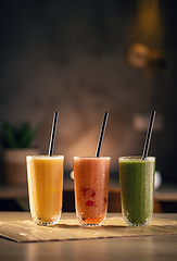Image showing Three colorful fruit smoothies