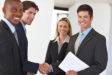 Image showing Business, document and handshake with colleagues and smile for deal, realtor or property or investment. Male person, team or shaking hands at house with paper or agreement, real estate with diversity