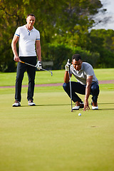 Image showing Men, play and aim golf ball at hole for sport, fitness or health in outdoor competition on summer day. People, watch and concentrate in tournament on green course for drive, hit and putt together