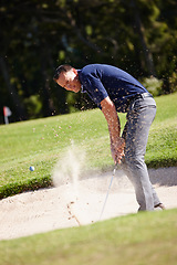 Image showing Man, golf and ball with sand outdoor, action and energy with club for game, competition and person. Challenge, exercise and professional athlete with training, performance and sports for leisure