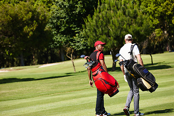 Image showing People, walking and outdoor on course for golf, game and training at club in summer. Golfer, friends and men on grass turf in park together talking about practice of sport with healthy competition