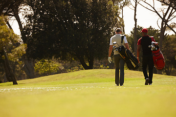 Image showing Walking, friends and men together on golf course with golfing bag for training, health and teamwork. Male people, sports equipment and exercise for activity with sportswear, lawn and trees outdoor