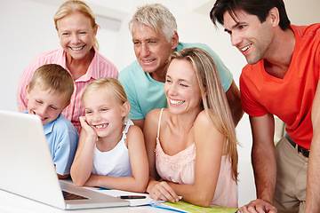 Image showing Happy, family and grandparents in lounge on laptop with children for entertainment at home for development. Parents, siblings and bonding on vacation to visit grandma, grandpa and childhood house