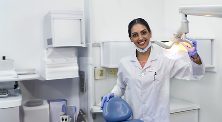 Image showing Dentist, portrait and woman by xray machine with smile for mouth care, dental health and service. Medical professional, happy and equipment in office for oral hygiene, dentistry and examination