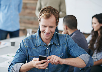 Image showing Happy man, phone and typing with meeting for social media, communication or networking in boardroom at office. Young male person with smile on mobile smartphone for online chatting, texting or app