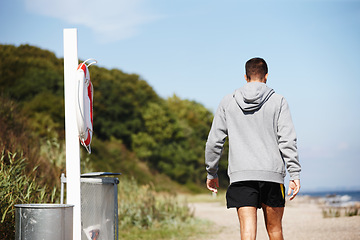 Image showing Rear view, man and jog for exercise on beach for fitness, workout and body health for physical training. Male runner or athlete and run for cardio, active strength or recreation in summer outside