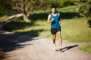 Image showing Man, outdoors and trail running for athlete with endurance with training for physical fitness. Male person, cross country and back for workout routine, race and drill for balance in performance