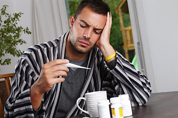 Image showing Man, thermometer for temperature and sick with headache, sinusitis or hayfever with virus at home. Health fail, medication or pills for cold or flu, monitor condition for allergies and infection