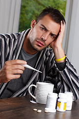 Image showing Man in portrait, thermometer for temperature and sick with headache, sinus or hayfever with virus at home. Health fail, medication or pills for flu, monitor condition for allergies and infection