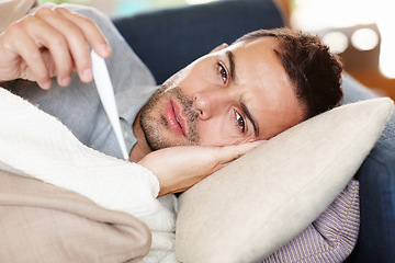 Image showing Man in couch, sick and thermometer for fever, healthcare and wellness with virus, viral infection or bacteria at home. Burnout, fatigue and health fail, monitor condition for illness with cold or flu