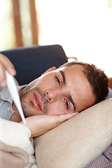 Image showing Man on sofa, sick and thermometer for fever, healthcare and wellness with virus, viral infection or bacteria at home. Burnout, fatigue and health fail, monitor condition for illness with cold or flu