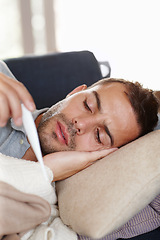 Image showing Man in living room, sick and thermometer for fever, healthcare and wellness with virus, viral infection or bacteria. Burnout, fatigue and health fail, monitor condition for illness with flu at home