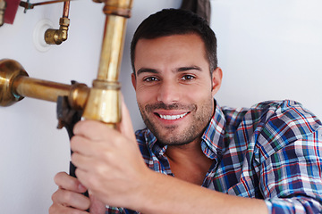 Image showing Portrait, man and plumber for fixing pipe as maintenance contractor for repair of leak from kitchen sink. Happy, person and technician with equipment, tools and wrench for home improvement