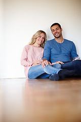 Image showing Happy couple, portrait and sitting on living room floor in new house for memories, drinks and home renovation. Dreaming, apartment and decision for decoration, interior design and future planning.