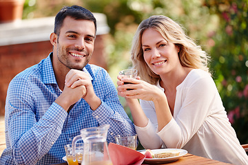 Image showing Portrait, happy and couple eating breakfast in garden outside at table in morning. Married, man and woman on romantic getaway at house sitting on patio talking, coffee and care for relationship