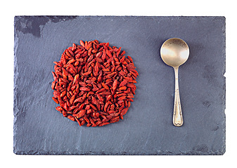 Image showing Pile, healthy and goji berries with spoon in studio for nutrition, organic and antioxidant as snack for health. Vegan, fruit and seeds produce vitamin c for wellness on isolated white background