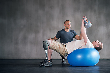 Image showing Trainer, person with a disability and prosthetic leg and dumbbell in physiotherapy, studio and gym ball. Male people, physiotherapy and amputee for wellness, fitness and exercise in rehab center