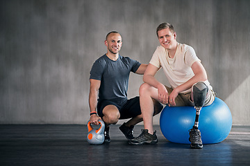 Image showing Physiotherapy, kettlebell and man with disability for fitness, training and muscle strength with coach for support. Amputee, exercise ball and physiotherapist for physical rehabilitation with workout