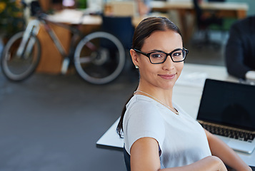 Image showing Woman, office and desk in portrait with confidence for career with work in administration job. Female person, workplace and table with laptop for review, feedback and online research with technology