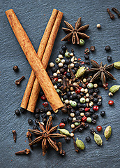 Image showing Whole spices, collection of ingredients and cooking for food, fragrance and flavor with culinary background. Stick cinnamon, star anise and cardamom with peppercorns for catering, seasoning and aroma