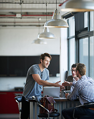 Image showing People, laptop and handshake at agency for meeting with collaboration, job contract and hiring. Tech, teamwork and hands for agreement in office with promotion, creative company and partnership deal