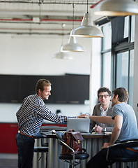 Image showing Professional man, partner and handshake with team in office for meeting, creative and company startup. Men, collaboration and business deal in modern workspace for agency, strategy and design