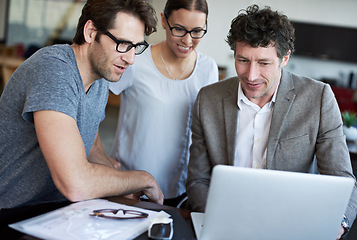 Image showing Serious, business people and meeting with laptop, documents and paperwork for collaboration on proposal. Teamwork, ceo and employee with feedback, planning and communication together in office