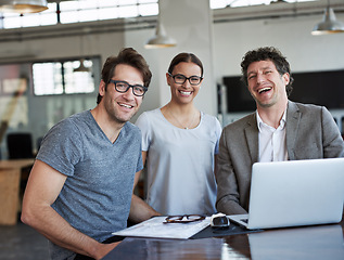 Image showing Team, laptop and portrait with laughing in office for working or collaboration. Businessmen, employees and technology with paperwork or documents in workplace for corporate, meeting or review