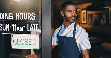 Image showing Man, business owner and restaurant with closed sign, thinking or check at startup, food or barista. Person, entrepreneur or waiter for cafeteria, diner or catering at door in apron, server or ideas