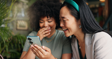 Image showing Happy women, friends and phone for social media at coffee shop for news, gossip or networking together. Young people smile and laughing on mobile smartphone for funny joke or meme at cafe restaurant