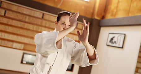 Image showing Aikido class, woman and fight for martial arts, strike or together for combat at training, gym or dojo. Japanese person, student and hands for exercise, workout or fitness with zen, conflict or club