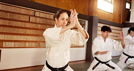 Image showing Aikido dojo, people and fight for martial arts, strike or together for combat at training, gym or class. Japanese students, group and sport for exercise, workout or fitness with zen, conflict or club