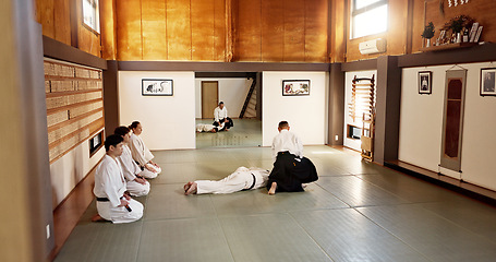 Image showing Students, aikido sensei or teaching Japanese martial arts in dojo for practice, body movement or self defense. Combat demonstration, group of people or training workout for black belt fighting class