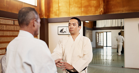 Image showing Aikido dojo, men and sensei for martial arts, learning or advice for combat at training, gym and class. Japanese people, moving hands or sport for fight, workout or fitness with zen, conflict or club